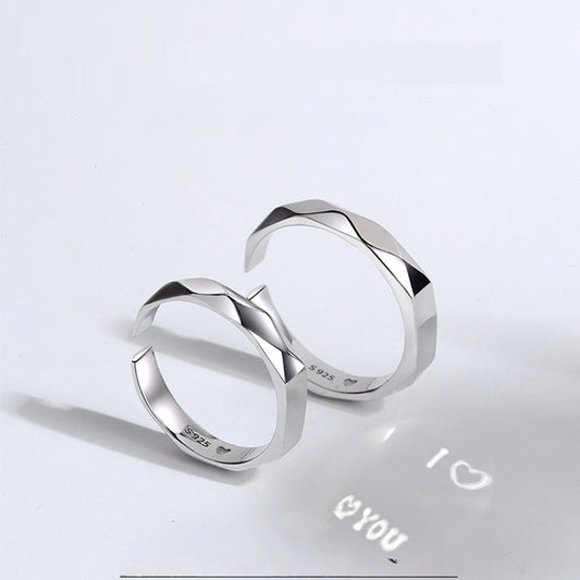 A close-up image of two Jingqian S925 Sterling Silver Light Reflection Rings with faceted surfaces, arranged in a mirrored fashion. A shadow below them displays the text "I ♡ YOU" with a heart symbol between "I" and "YOU", creating a romantic impression enhanced by the light reflection from the rings.