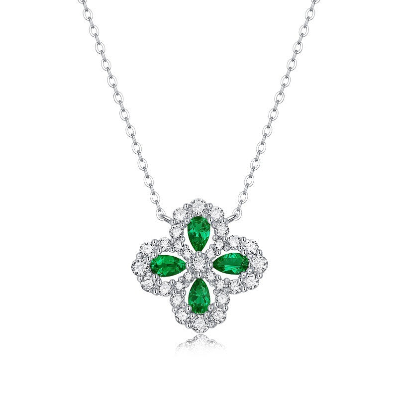 Silver necklace with a green emerald pendant on a white background