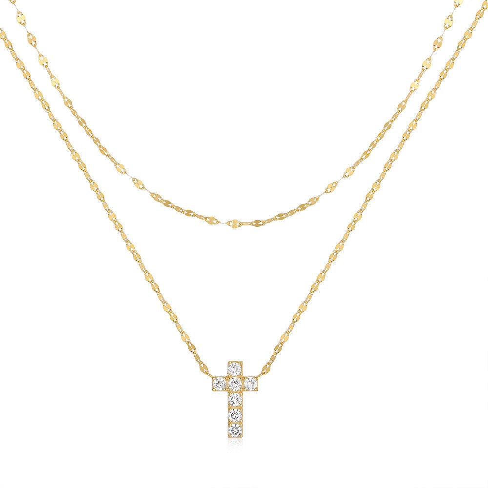 Gold necklace with a cross pendant on a white background