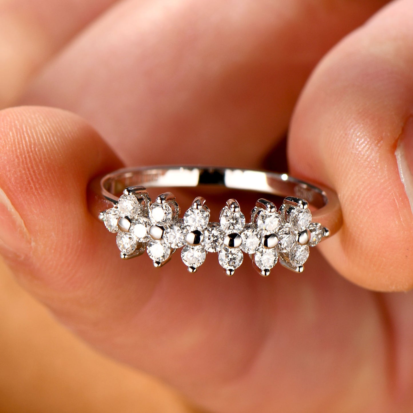 Diamond ring on a finger with a blurred background