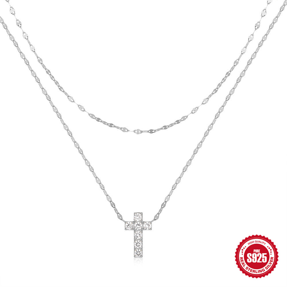 Silver cross necklace on a white background with '925 Sterling Silver' stamp.