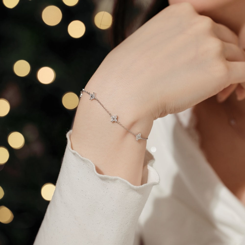 Silver bracelet on a wrist with a blurred bokeh background