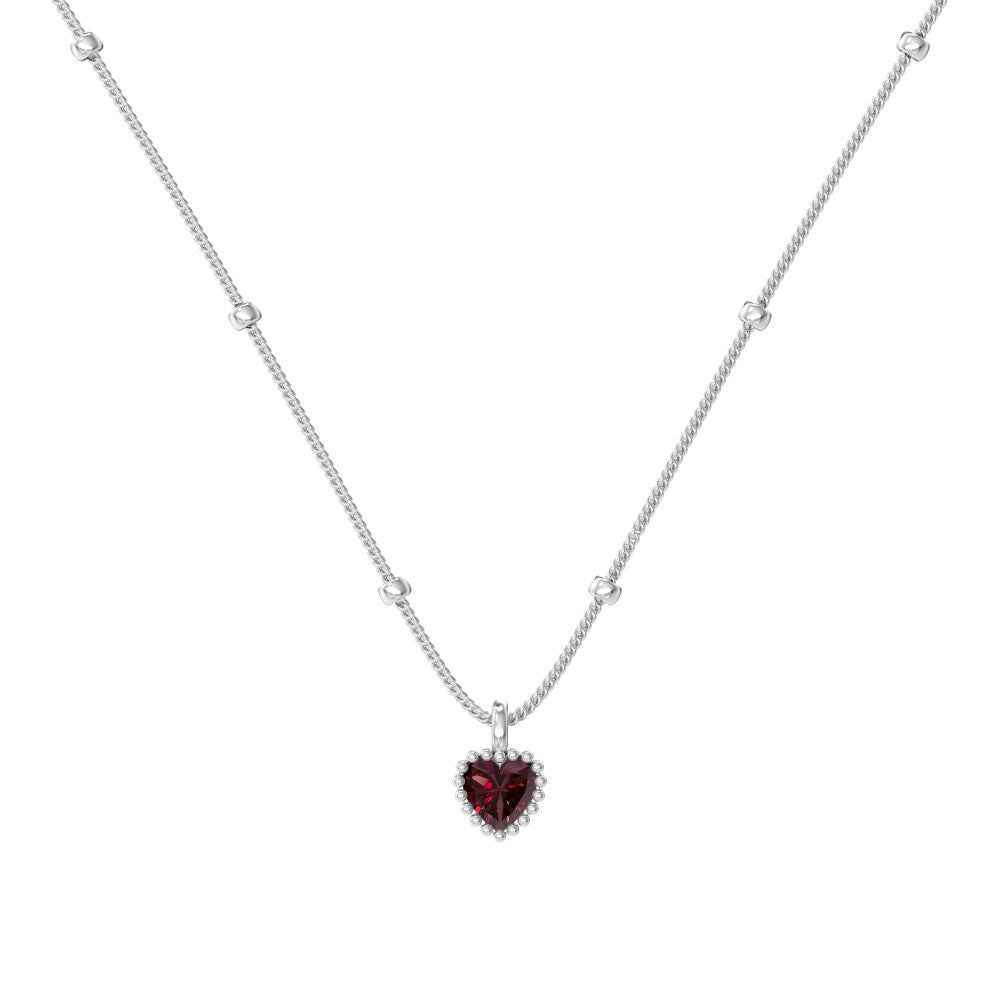 Necklace with a heart-shaped red gemstone pendant on a white background