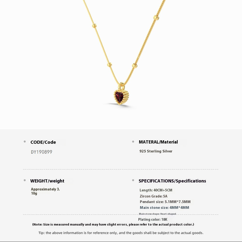 Gold necklace with a heart-shaped pendant on a white background