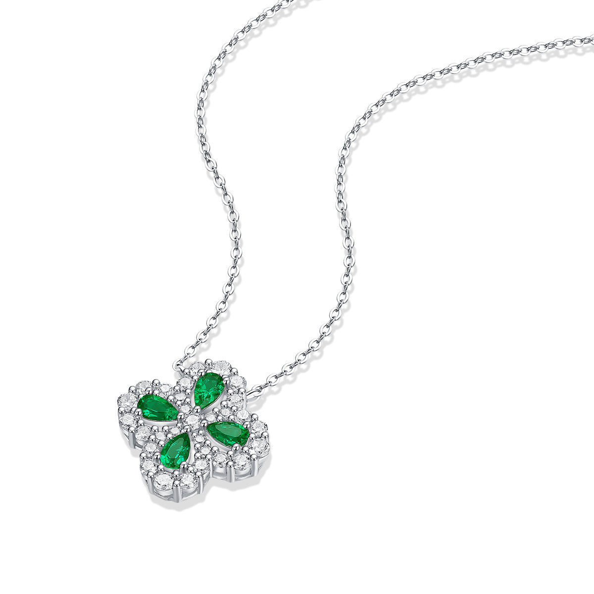 Silver necklace with a clover-shaped pendant featuring green gemstones on a white background